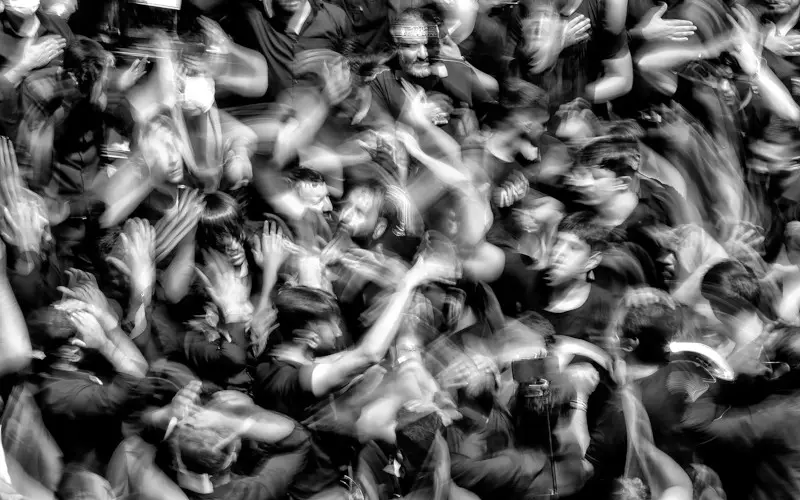 Blurred crowd of people in motion, illustrating how fast emotional contagion can spread